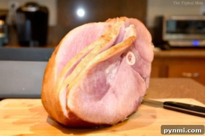 Decadent Bourbon Glazed Ham 4 a whole ham on a platter, ready to be glazed