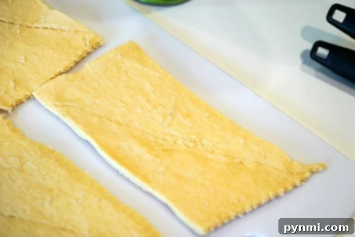 Unrolled crescent rolls ready for filling, highlighting the ease of this recipe.