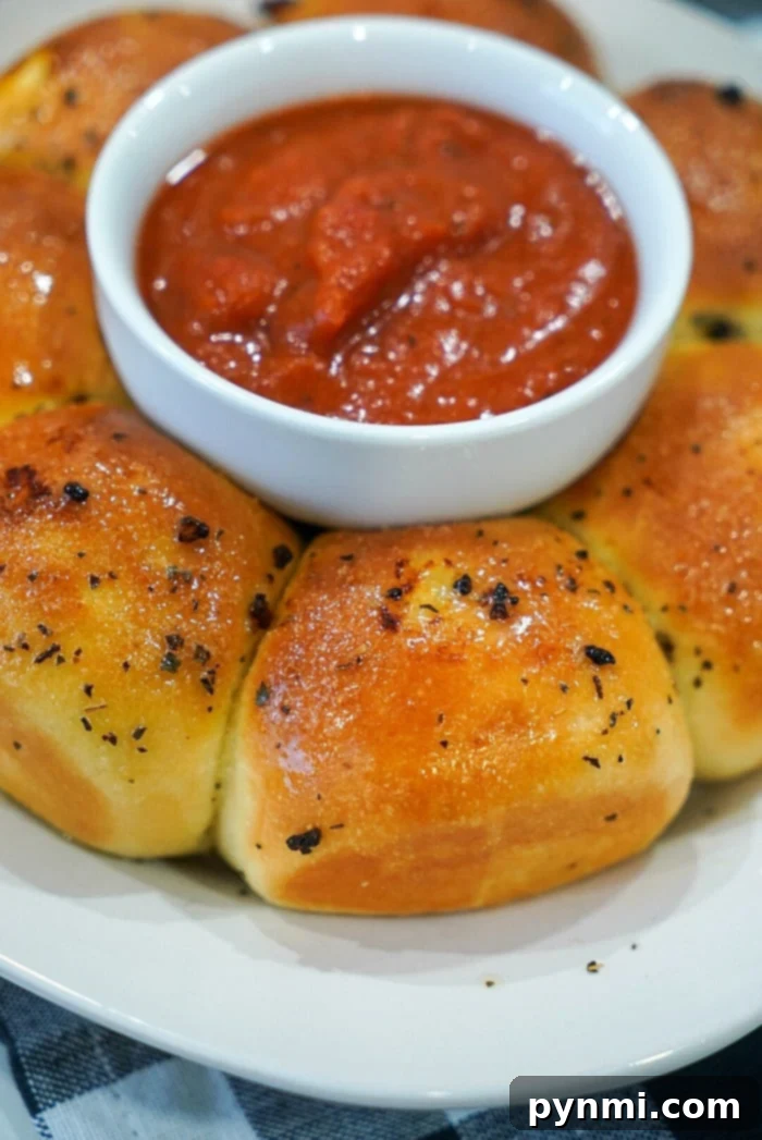 Perfectly Crispy Air Fryer Frozen Rolls 2 Golden brown air fryer garlic bread rolls arranged beautifully on a plate, ready to be served.