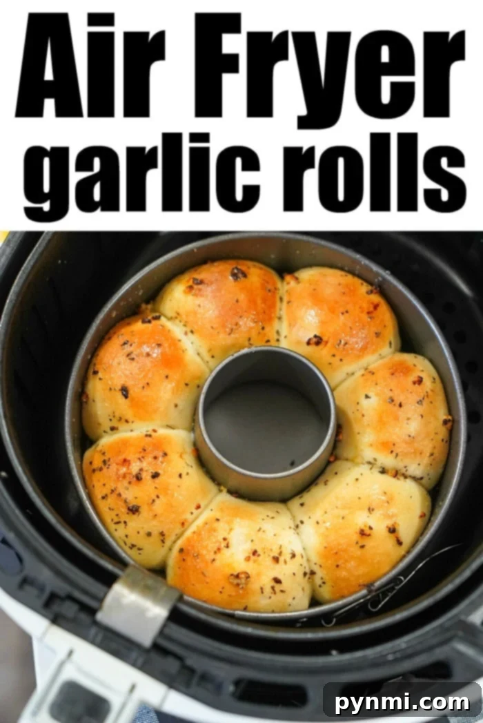 Perfectly Crispy Air Fryer Frozen Rolls 11 Close-up of golden, fluffy garlic bread baking in an air fryer basket, steam gently rising, showcasing perfect texture and color.