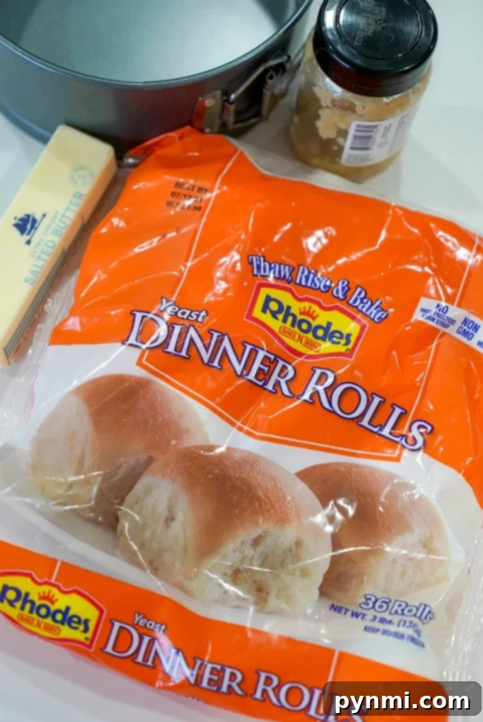 Perfectly Crispy Air Fryer Frozen Rolls 3 Close-up of Rhodes frozen rolls beginning to thaw and rise in a non-stick sprayed pan, ready for the air fryer.