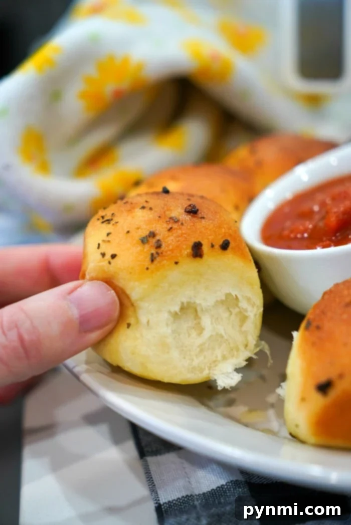 Perfectly Crispy Air Fryer Frozen Rolls 9 A basket full of golden brown Rhodes rolls, fresh from the oven, showcasing their perfect texture.