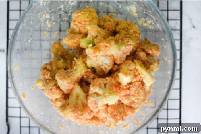 Panko Crusted Air Fryer Buffalo Cauliflower Wings 6 Cauliflower florets generously coated in buffalo sauce and golden Panko breadcrumbs, ready for the air fryer.