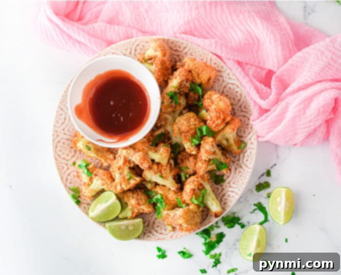Panko Crusted Air Fryer Buffalo Cauliflower Wings 8 A basket full of hot and spicy Ninja Foodi cauliflower wings, perfectly cooked and ready to be served as a delightful snack.