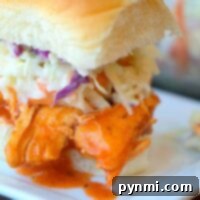 Instant Pot buffalo chicken slider with coleslaw elegantly presented on a square white plate.