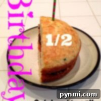 Half birthday cake with a candle, text Birthday 1/2 Celebrations on a tiled surface.