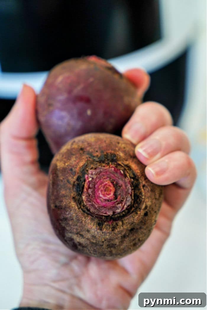 Sweet and Tender Air Fryer Beets 3 Whole, unpeeled beets on a wooden cutting board