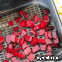 Sweet and Tender Air Fryer Beets 7 Air fryer beets are ready for cooking as chopped beets fill the basket, promising a delicious and healthy treat.