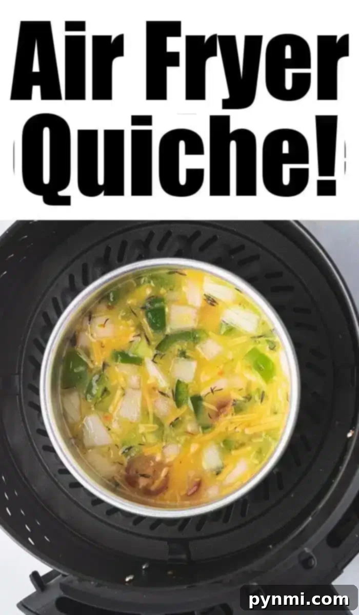 Effortless Air Fryer Quiche 7 A delicious air fryer quiche with vibrant vegetables is cooking to perfection. Overhead, bold text proudly announces "Air Fryer Quiche!