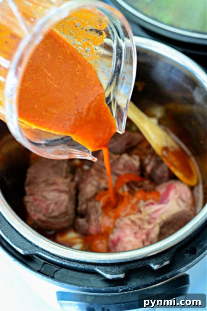 Mouthwatering Instant Pot Barbacoa 6 Instant Pot Barbacoa Beef – a vibrant platter of shredded barbacoa beef, garnished with cilantro, lime, and served with tortillas and toppings.