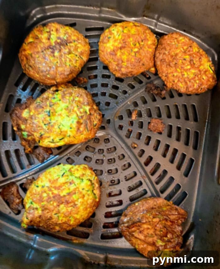 Pile of low carb zucchini fritters on a wooden board