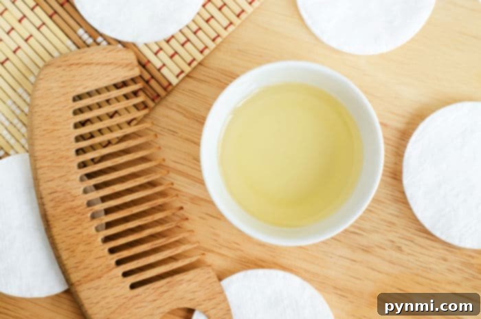 Olive Oil Magic: Enhancing Your Hair and Your Meals 4 A woman applying olive oil to her hair for natural conditioning.