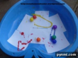 Kids creating rainbow marble paintings on paper
