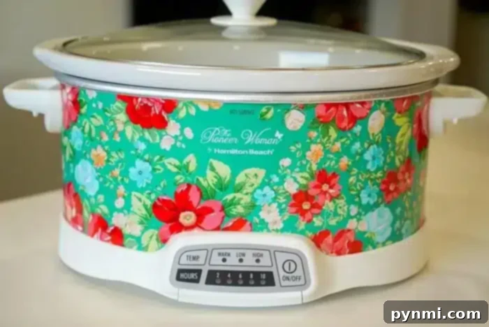 Luscious Slow Cooker Chocolate Nut Bites 3 A floral design slow cooker with a white base and lid sits on a kitchen countertop, perfect for whipping up a 5 ingredient crockpot chili recipe, or delicious chocolate candy.