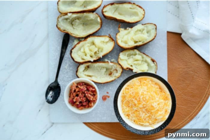 twice stuffed potatoes - Close-up of loaded potato skins, overflowing with melted cheese, bacon, and herbs, ready to be served.