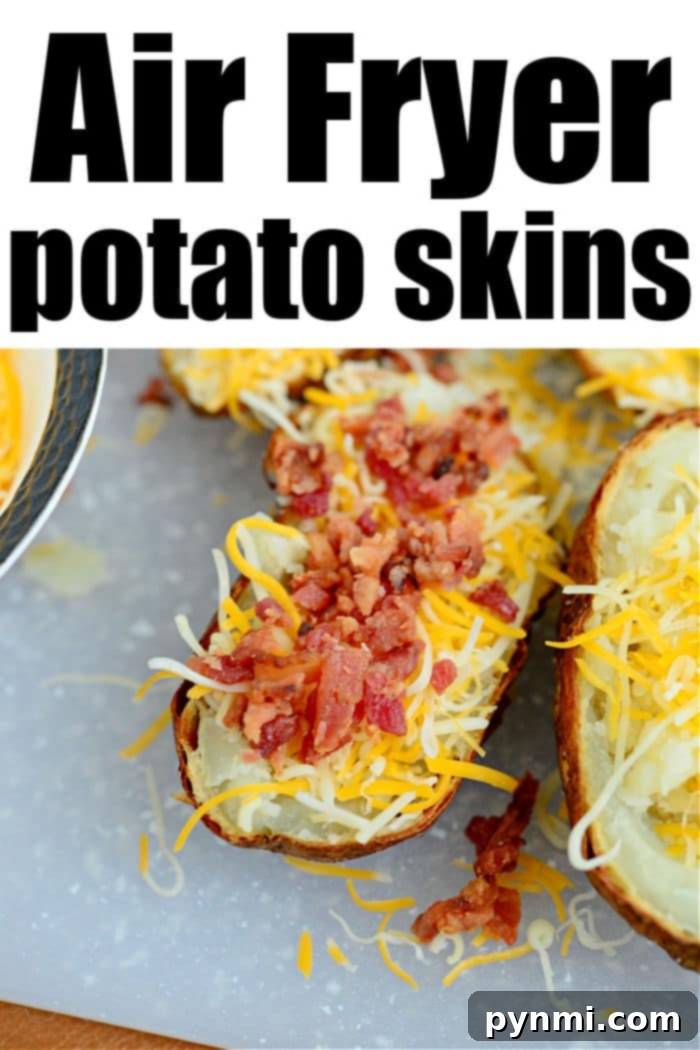 potato skins air fryer - A batch of uncooked potato skins, already filled and topped with cheese and bacon, ready to be air-fried.