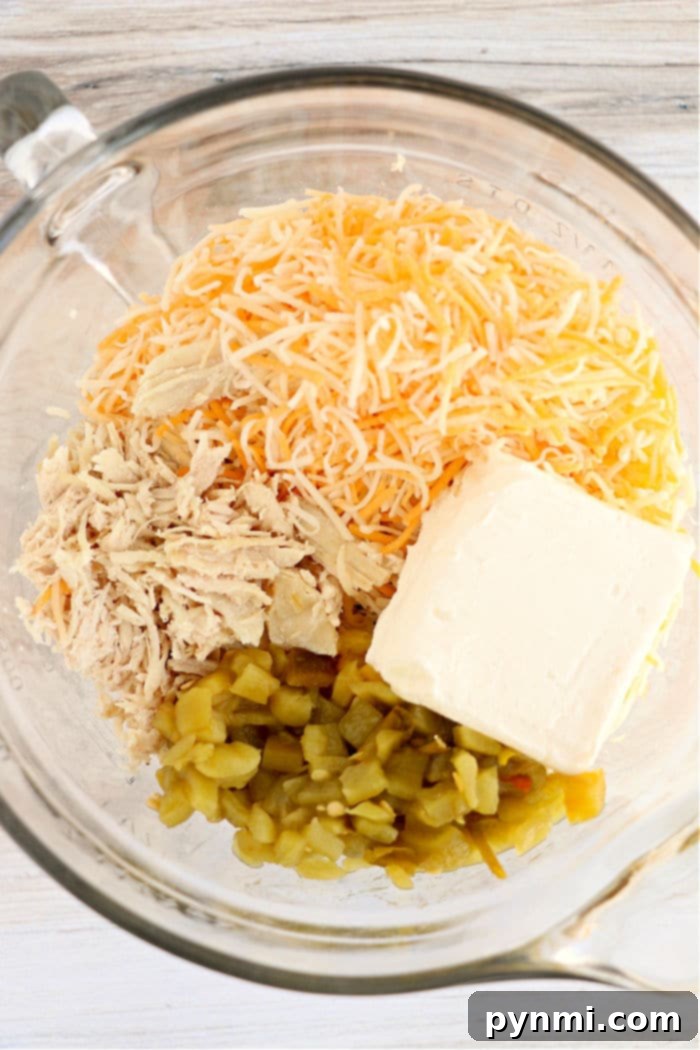 A close-up view of the creamy, savory chimichanga filling mixture, perfectly combined in a large bowl.