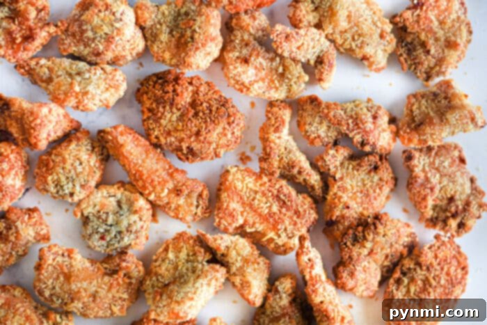 Crispy Air Fryer Popcorn Chicken 9 Close-up of crispy popcorn chicken pieces with a golden-brown crust, showcasing the texture achieved with air frying.