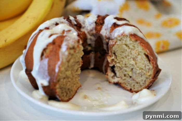 Close-up of a warm, golden slice of air fryer banana bread, showing its moist texture.