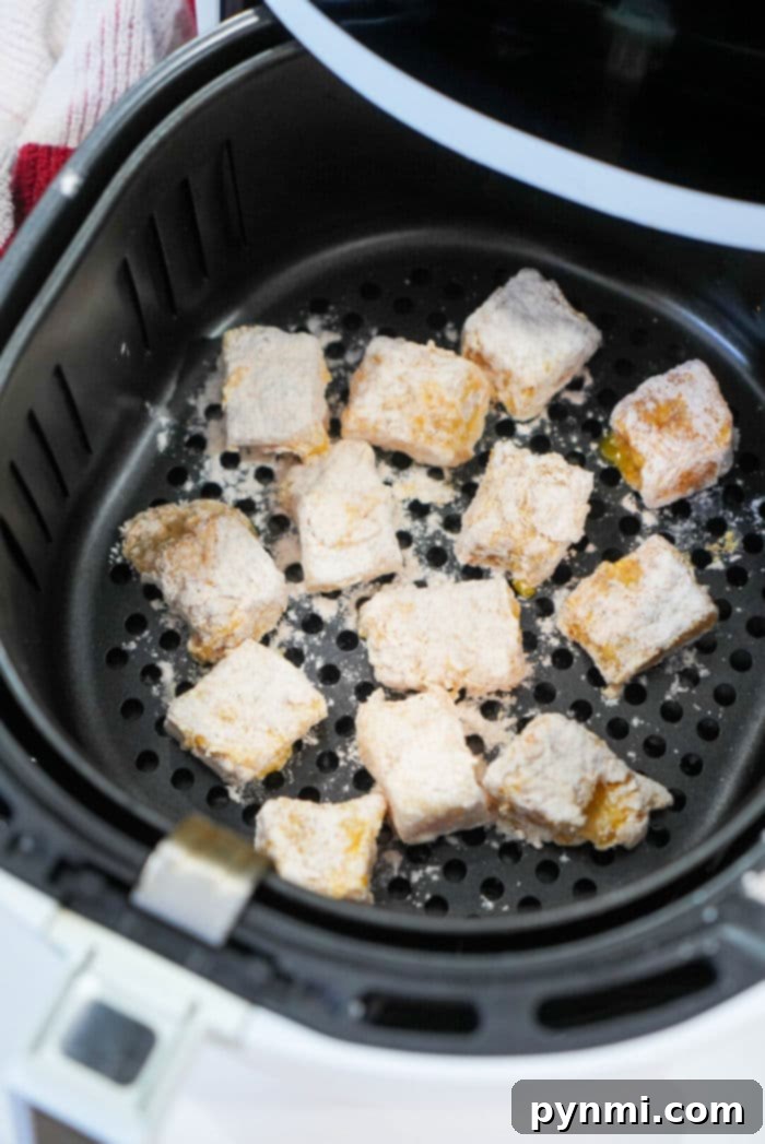 Golden Air Fryer Fish Bites 10 A basket full of golden air fryer fish bites, perfectly crispy.