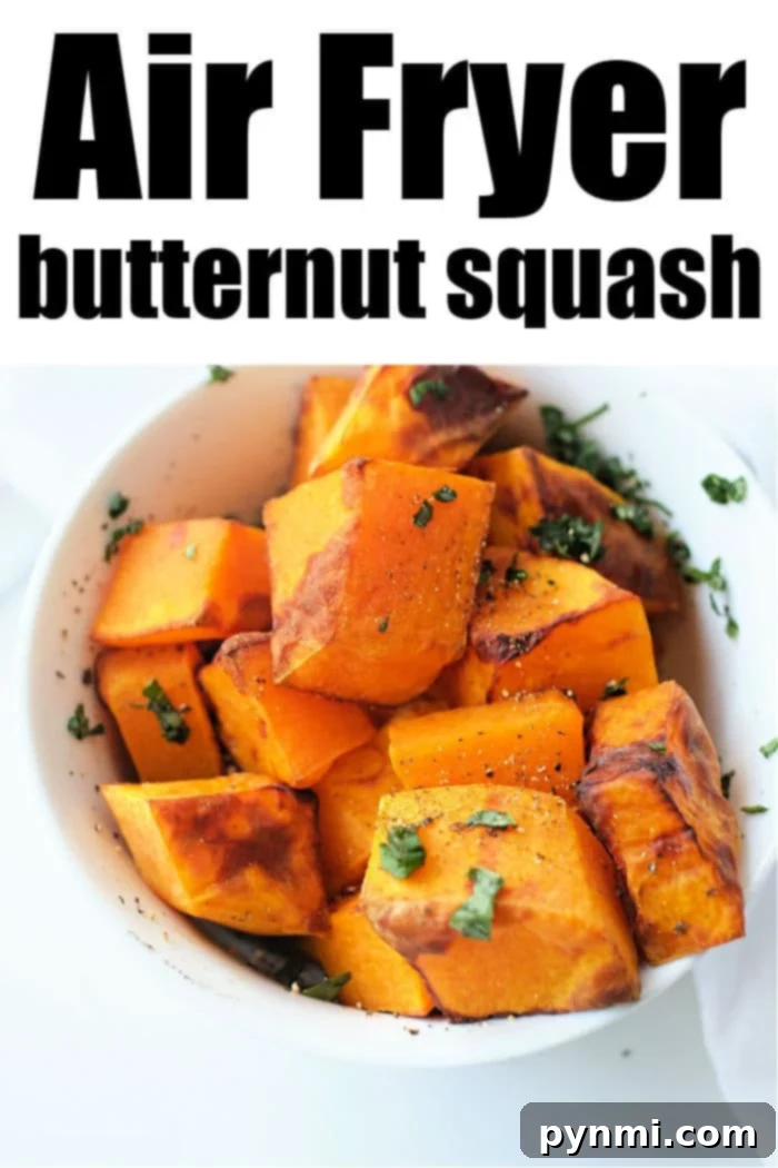 Golden Air-Fried Butternut Squash 8 Close-up of roasted butternut squash cubes in an air fryer basket.