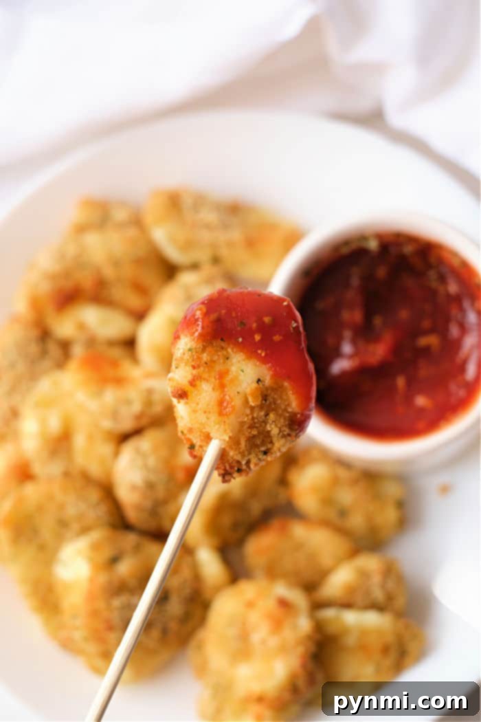 Golden Crispy Air Fryer Cheese Curds 2 Crispy cheese curds cooked in an air fryer, golden brown and ready to eat.