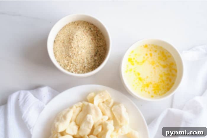 Golden Crispy Air Fryer Cheese Curds 4 Breadcrumb coating in a shallow bowl, essential for crispy air fryer cheese curds.