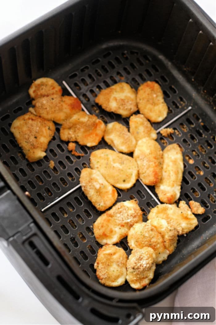 Golden Crispy Air Fryer Cheese Curds 7 Plate of perfectly air-fried frozen cheese curds, golden and ready for dipping.
