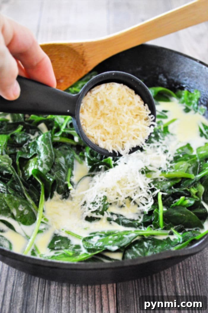 A bowl of easy creamed spinach, beautifully garnished, ready to be served as a delightful and comforting side dish for any meal.