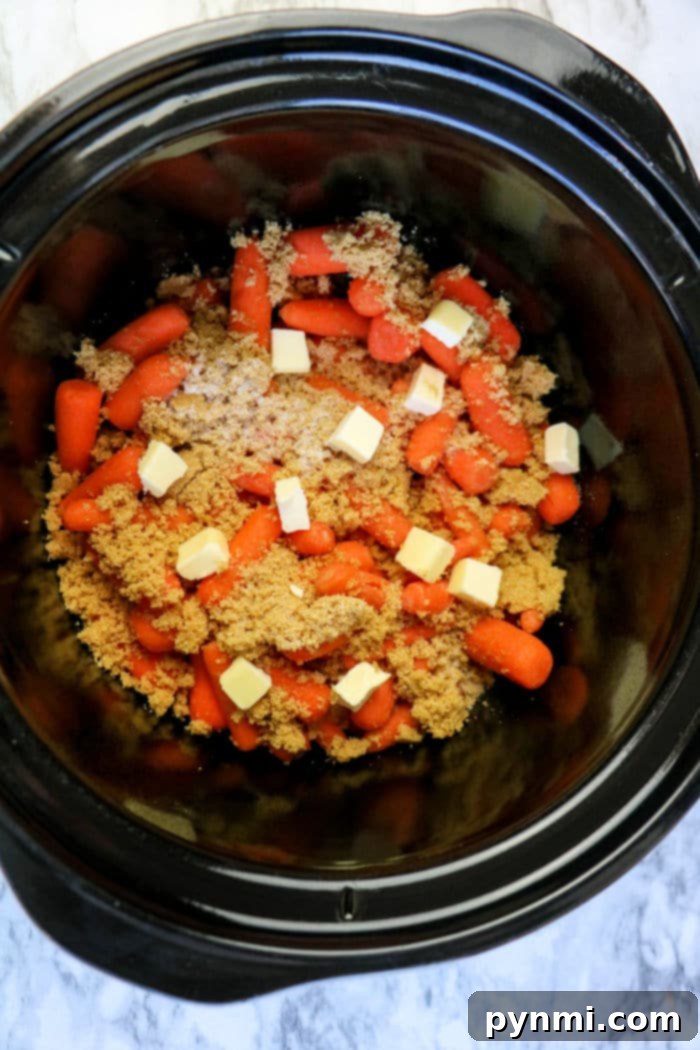 Effortless Crockpot Carrots 4 A vibrant bowl of Crockpot glazed carrots, beautifully coated and ready to be served.