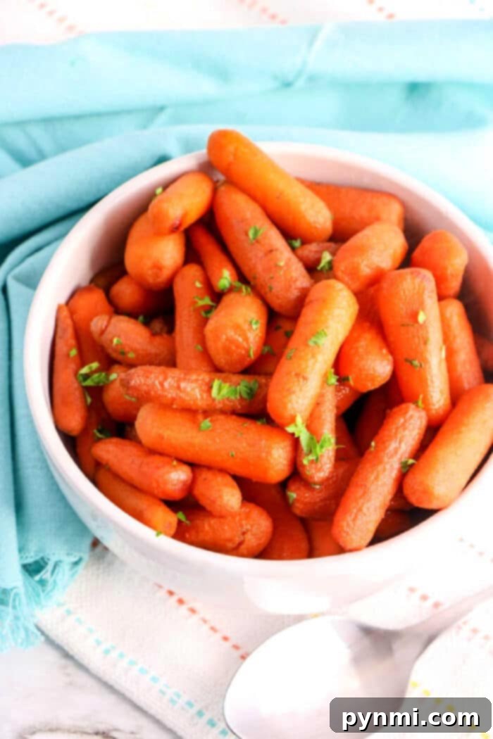 Effortless Crockpot Carrots 7 A serving of beautifully Glazed Crockpot Carrots, shining with a delicious caramel coating.