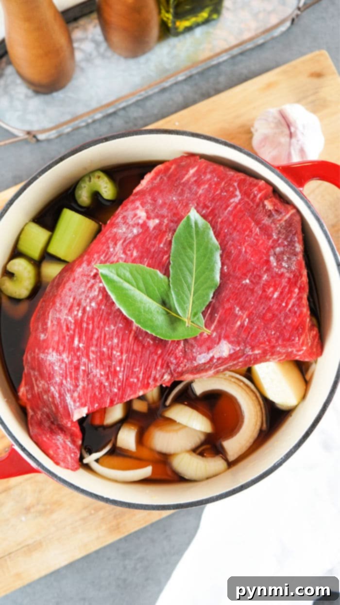Slow Braised Dutch Oven Tri Tip 5 Cooked tri tip roast in a dutch oven with vegetables ready to be served.