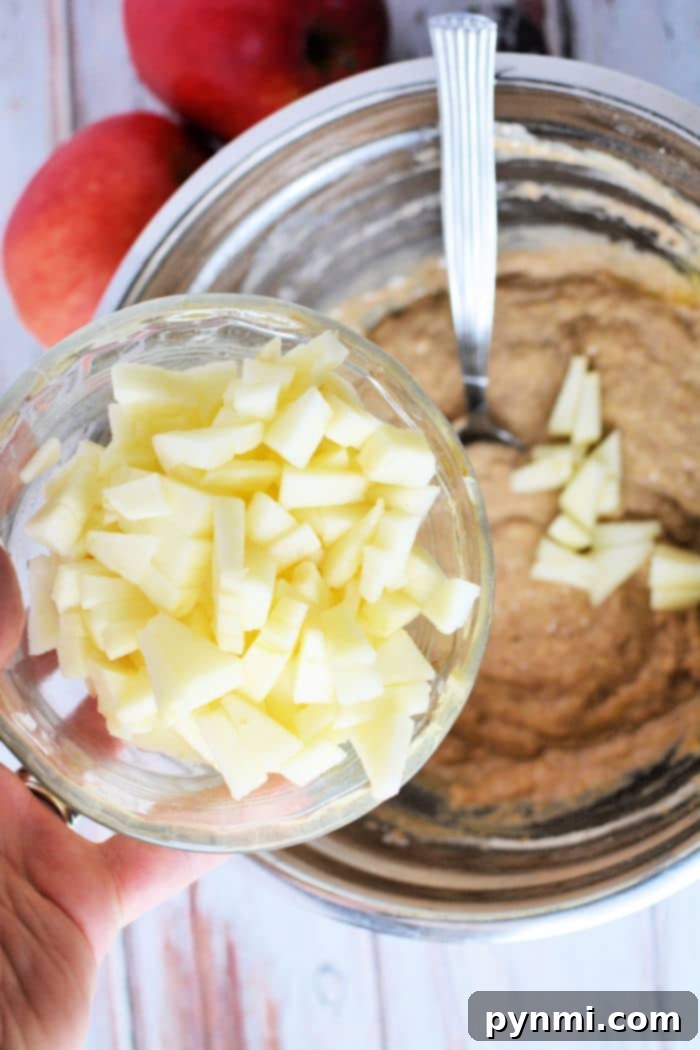 Freshly prepared apple fritter batter with diced apples, ready for air frying.
