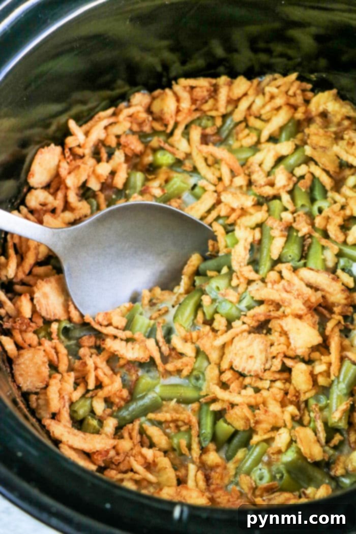 Close-up of Green Bean Casserole being cooked in a slow cooker.