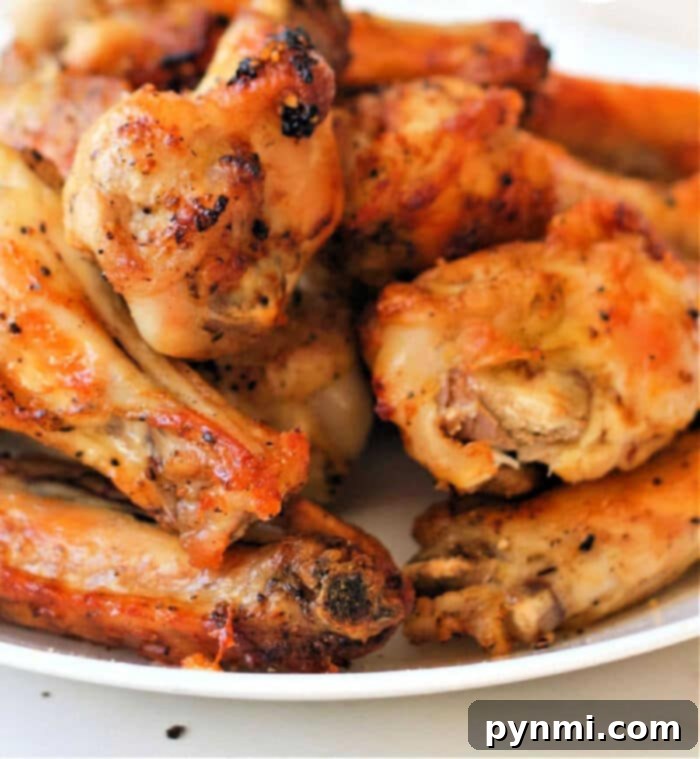A plate brimming with golden-brown lemon pepper chicken wings, a delectable air fryer creation.