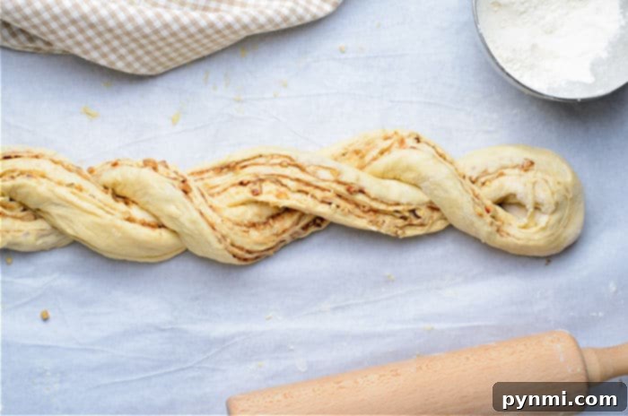 Beautiful Braided Bread 8 Homemade wreath bread fully braided and shaped into a circle on parchment paper, ready for its final proof.