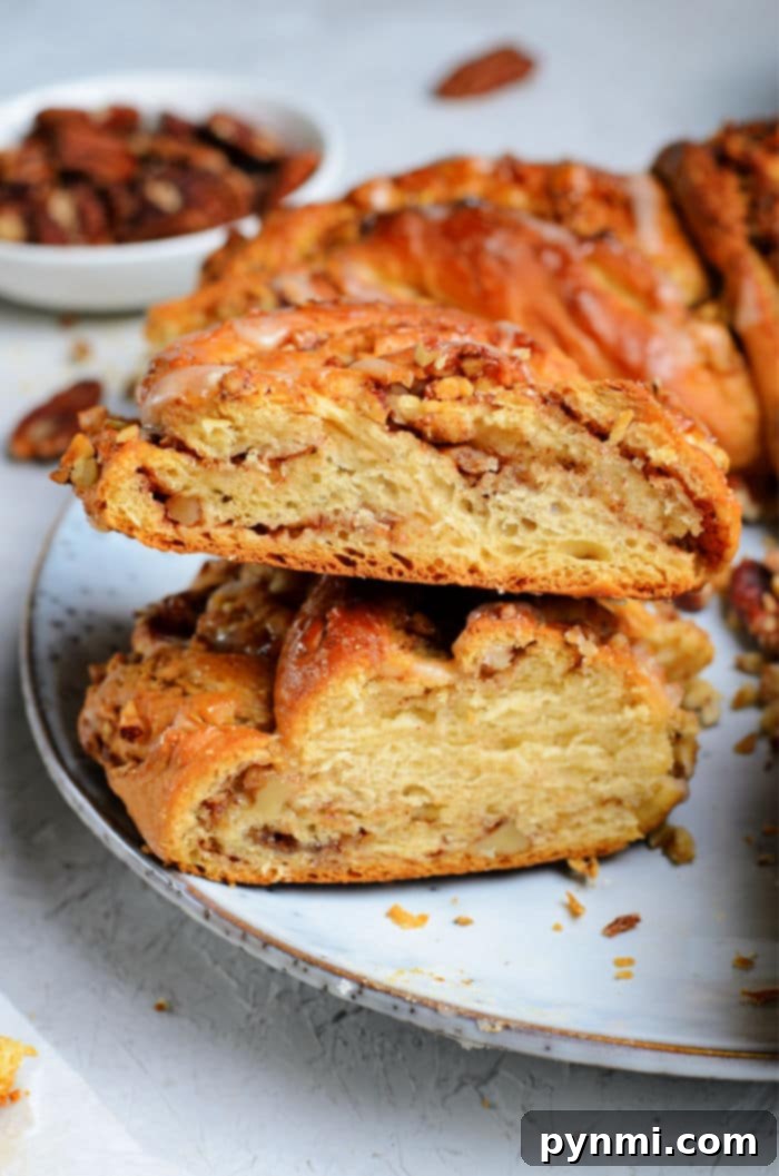 Beautiful Braided Bread 10 A delicious homemade wreath bread recipe with a beautiful glaze, served in slices and garnished with pecans.