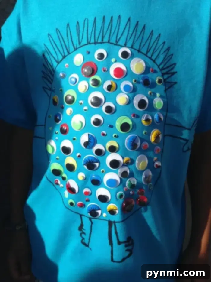 A young boy proudly wearing a '100 Days of School' shirt adorned with small plastic toy soldiers, showcasing a creative DIY idea.
