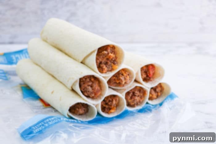 Crispy Air-Fried Flautas 7 Stacked beef and cheese taquitos, perfect for the air fryer, are nestled in clear plastic packaging, showcasing the delicious filling.