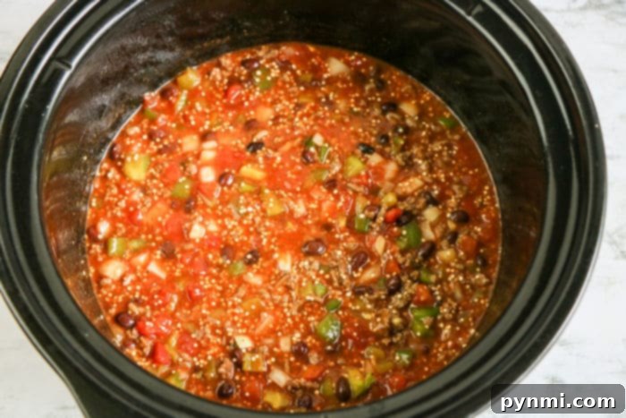 A serving of a rich, cheesy enchilada casserole, showcasing the melded ingredients and vibrant colors, ready to be served.
