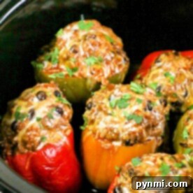 Effortless Slow Cooker Stuffed Bell Peppers 7 Crockpot stuffed bell peppers bursting with colorful cheese and herbs, slowly cooked to perfection.