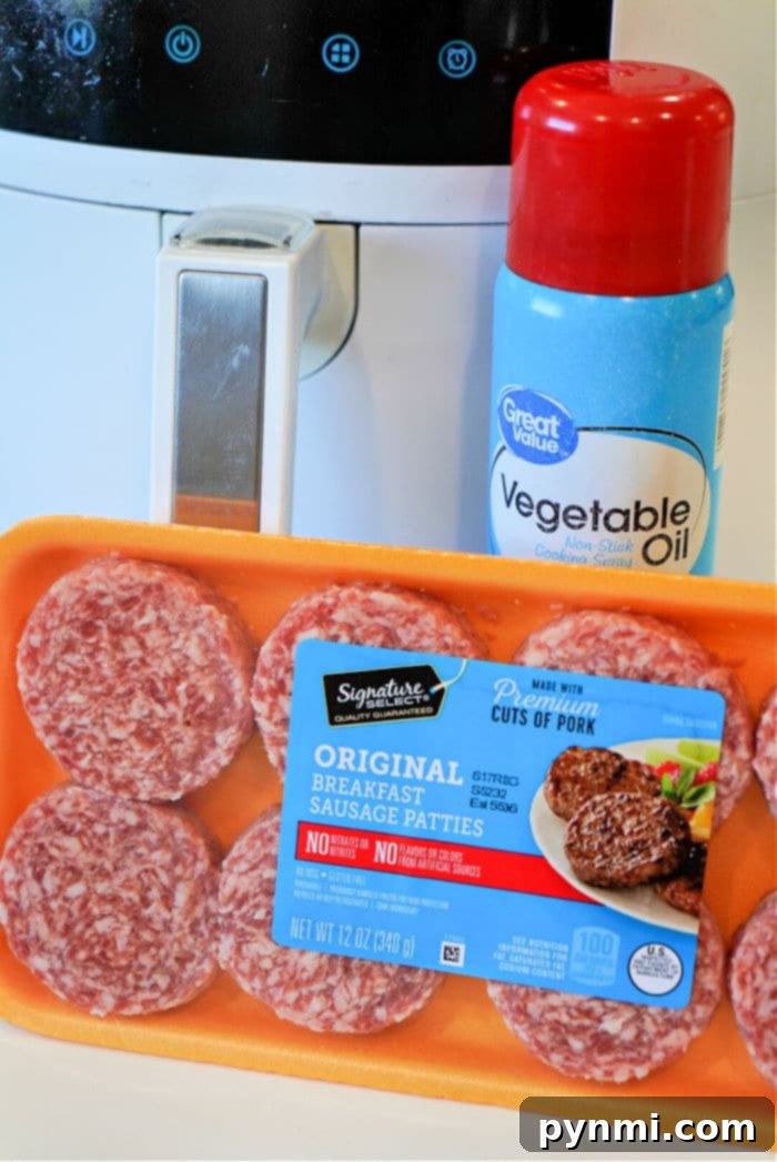 Sausage patties cooking evenly in an air fryer basket.