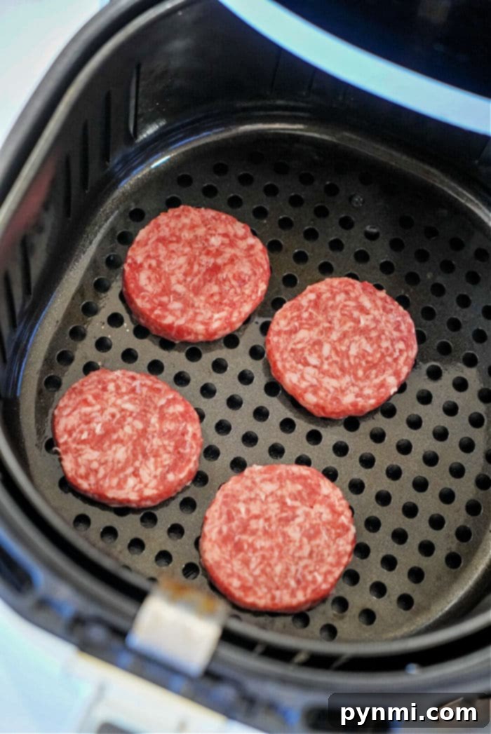 Close-up of golden-brown sausage patties cooked in an air fryer.