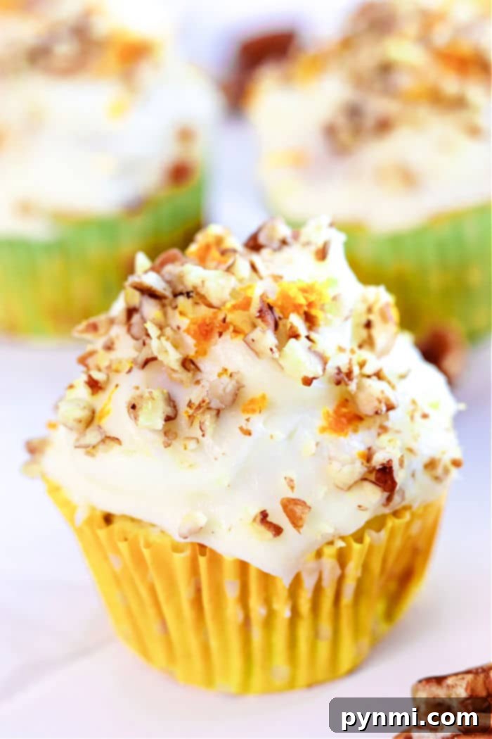 Wholesome Zucchini Carrot Muffins 10 A delightful carrot muffin with cream cheese frosting, sprinkled with chopped nuts, all nestled in a vibrant yellow wrapper. Inspired by the warmth of zucchini carrot muffins, it balances sweetness and texture perfectly.
