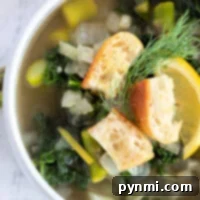 Vibrant Asparagus Spinach Soup 4 Bowl of asparagus and spinach soup topped with croutons, garnished with a lemon slice and dill.