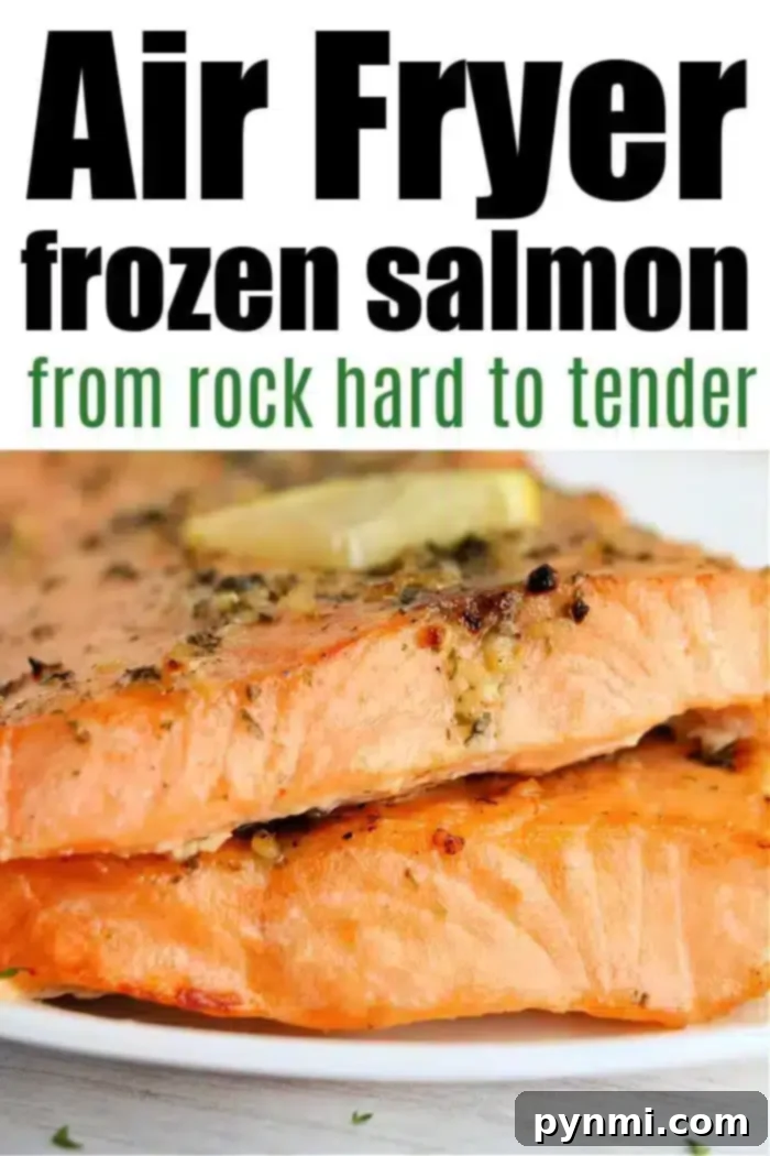 Close-up of two cooked salmon fillets, seasoned with herbs and topped with a slice of butter on a white plate. Text at the top reads, "Frozen salmon in air fryer: from rock hard to tender.