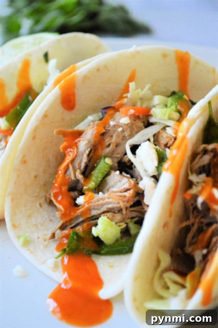 Smoky Pulled Pork Tacos 2 Instant Pot Pork Tacos, shredded pork piled high with cabbage and sauce