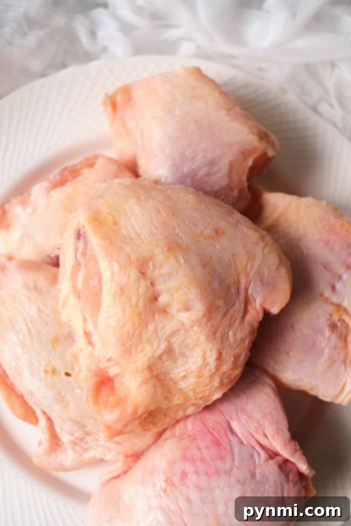 Mastering Frozen Chicken Thighs in Your Air Fryer 4 A stack of frozen chicken thighs, bone-in and skin-on, waiting to be cooked in an air fryer.