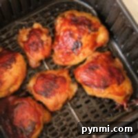 Air fryer frozen chicken thighs come out browned and crispy, with a beautifully glazed appearance that rivals any fresh preparation.