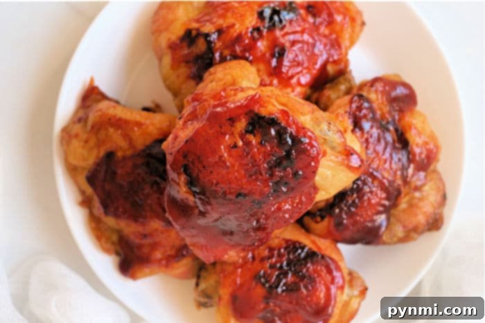 Mastering Frozen Chicken Thighs in Your Air Fryer 8 Two barbecued chicken thighs, perfectly glazed and ready to eat, served on a plate.